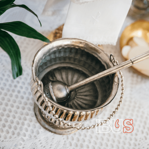 Recipiente con agua bendita y aspersorio, relacionado con el ritual católico para bendecir la cerveza